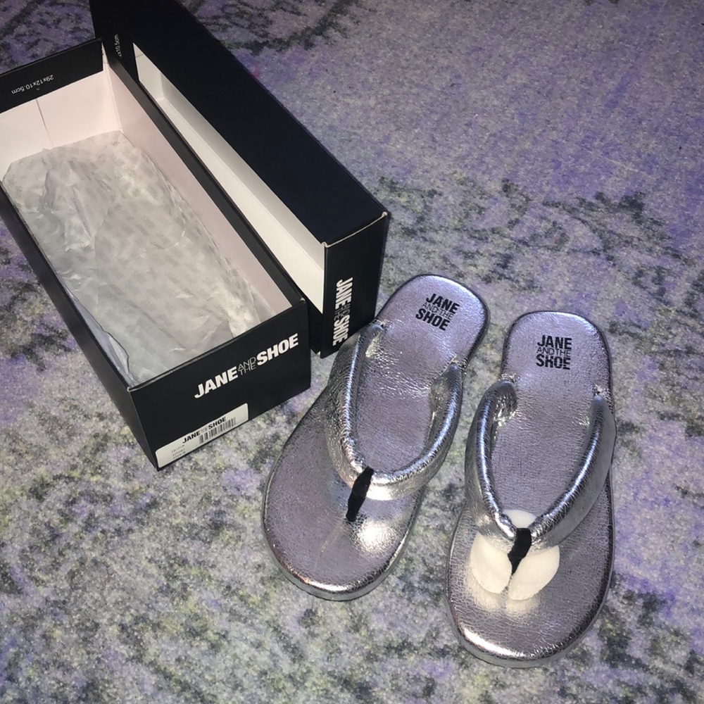 Metallic silver flip flops